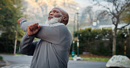 Obraz premium Fitness, start or black man outdoor with stretch, arm mobility or injury prevention in retirement activity. Wellness, active or senior person with preparing, shoulder or muscle improvement in warm up