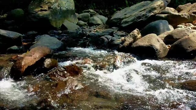 The river flows steadily across a rocky bed, its current calm and unforced. This kind of natural sound is often turned to as a simple aid for falling asleep.
