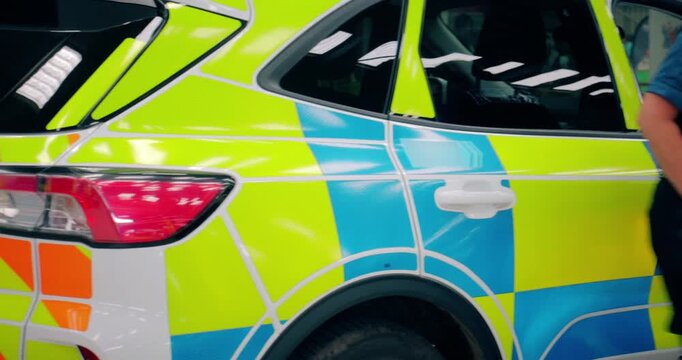 Police officer and police car - scene of emergency services' cop and police force road vehicles in action, featuring a law enforcement car and van at crime scene in response to an incident.