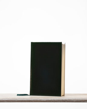 Black cover book on the wooden shelf. Abstract image for , cozy moments, reading hobby minimalist image for design copy space