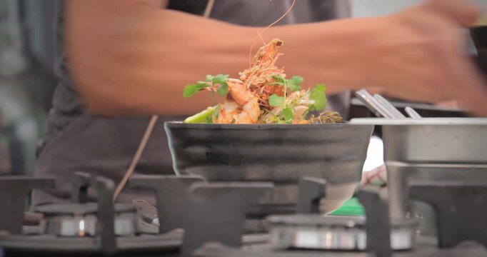 Chef cooking food dish in professional kitchen