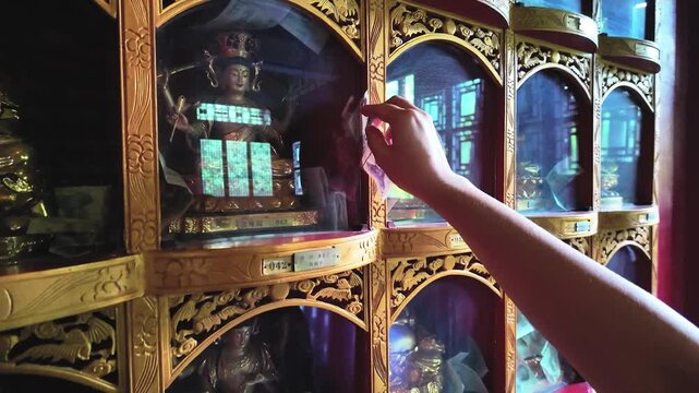 Offering money in a Buddhist temple (called Dana or the practice of generosity) is a voluntary ritual to accumulate good karma and cleanse the mind of greed.