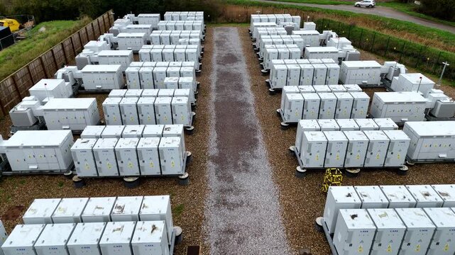 Detailed drone footage of secure containerised battery energy storage systems supporting regional power resilience, Burwell, UK.