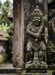 Fototapeta premium Carved Stone Guardian Statue At Balinese Portal