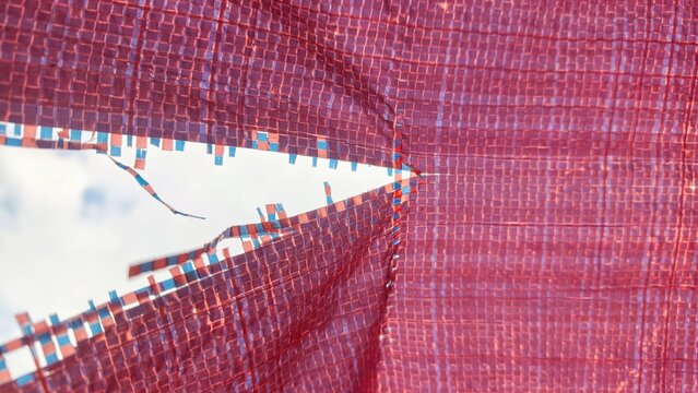 Canvas or tarpaulin torn from being left outside and rotting when exposed to rain and hot sun