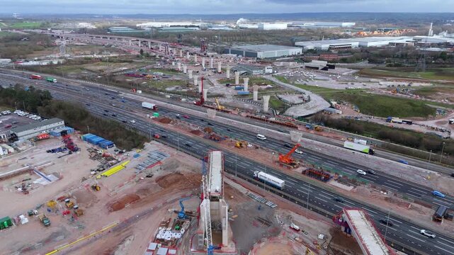 Aerial view of major HS2 civil engineering works and construction of concrete high-pass viaduct beams in Coleshill, Warwickshire, UK.