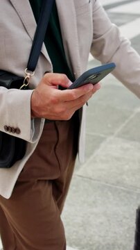 Businessman, hands and phone with suitcase in city for work trip or business travel. Man, employee or traveler with smartphone or luggage for app, career opportunity or job commute in an urban town