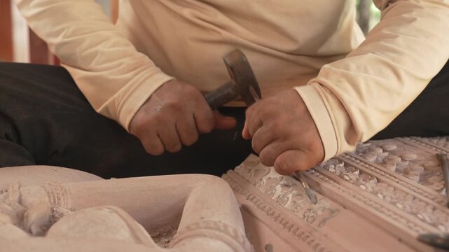 Cambodian Artisan Hand Carving Traditional Stone Sculpture with Chisel
