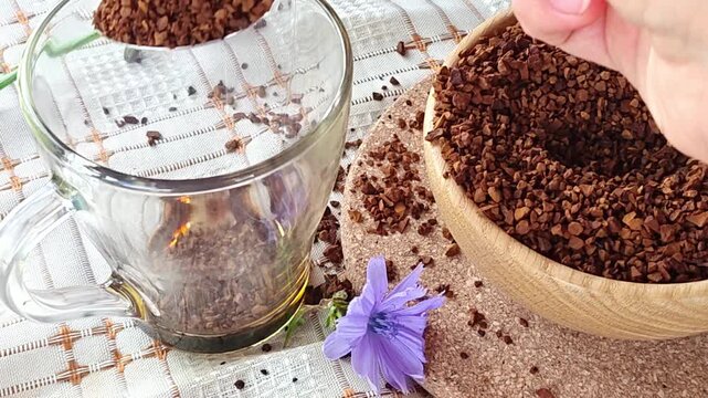 Ground chicory root, chicory flowers and chicory drink on a rustic wooden background. Alternative medicine. Healthy drinks