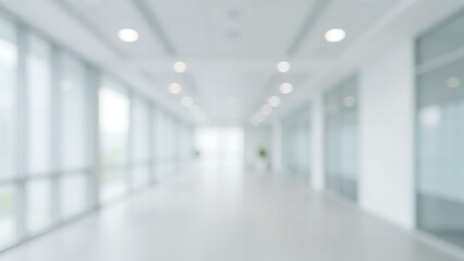 Fototapeta premium Blurred office building hallway with glass walls and bright ceiling lights