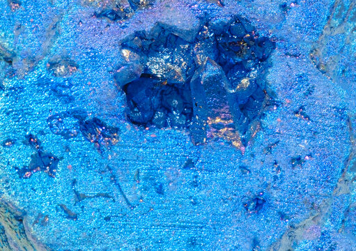 Close up of blue crystal formations and mineral textures with shimmering light