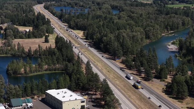 Aerial of Interstate 90 through forested valley with lakes and Yakima river in Cle Elum Washington in summer