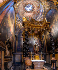 Baroque baldachin with black marble solomonic columns inside the Chapel of San Pedro Arbues at the Cathedral of La Seo, ornate interior architecture in Zaragoza. © javier
