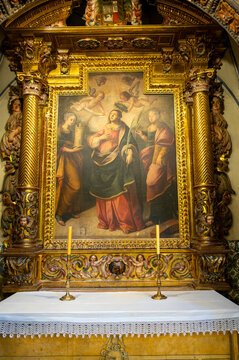 Ornate gilded altarpiece and chapel altar with religious painting inside the Cathedral of San Salvador, La Seo in Zaragoza, Spain.