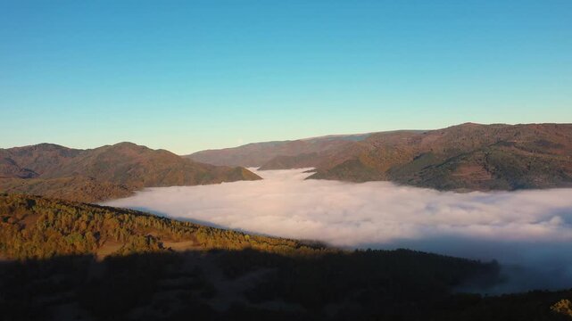 Aerial view of autumn morning fog and clouds in the valley