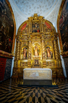 Vertical view of the gilded baroque altarpiece inside the Chapel of Saint Valerius featuring San Valero and side paintings at La Seo Cathedral in Zaragoza.
