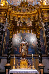 Baroque baldachin with black marble solomonic columns inside the Chapel of San Pedro Arbues at the Cathedral of La Seo, ornate interior architecture in Zaragoza. © javier