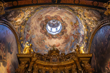 Baroque baldachin with black marble solomonic columns inside the Chapel of San Pedro Arbues at the Cathedral of La Seo, ornate interior architecture in Zaragoza. © javier