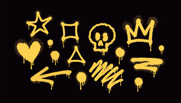 Yellow spray paint graffiti icons set, street art doodles with crown, skull, heart, and arrow isolated on black background