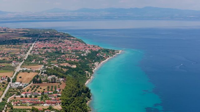 Aerial view of turquoise sea and coastal village