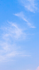 Obraz premium Beautiful clear blue sky with soft wispy white cirrus clouds, perfect for summer nature background and abstract copy space texture.