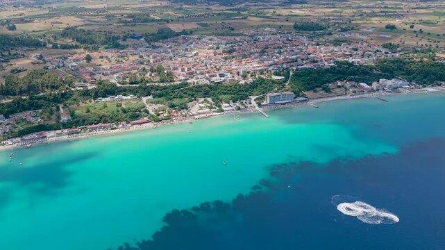 Aerial View of Turquoise Sea with Coastal Town and Beach