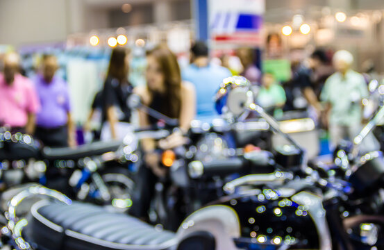 blurred sexy woman in motorcycle showroom.