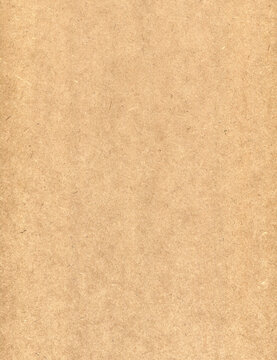 Brown hardboard texture background. Light fiberboard wood plate surface close-up
