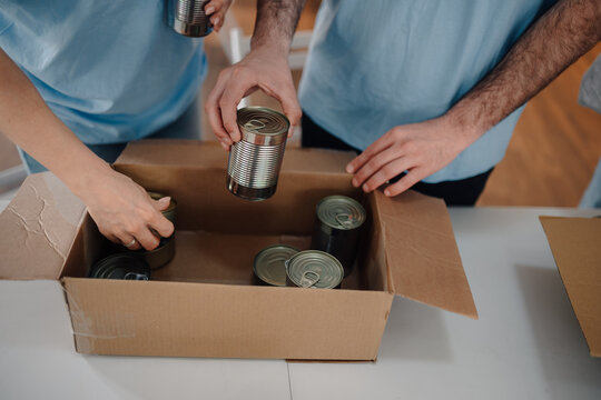 Volunteers packing canned food donations for charity drive