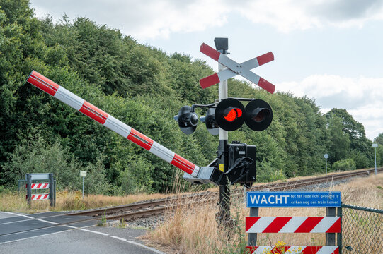 Lievelde railroad crossing barrier with red warning lights