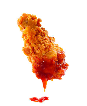 Crispy fried chicken dipped in spicy chili sauce