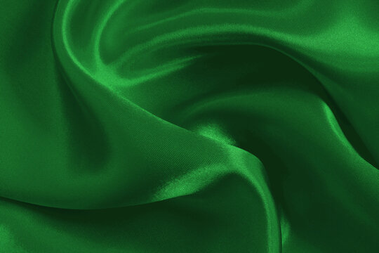 Green emerald fabric texture background, detail of silk or linen pattern.