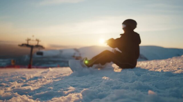 Beautiful sunset in mountain, woman snowboarder relaxing at top in ski resort. Skiing and snowboarding, tourism and travel in winter vacation, extreme sport for get adrenaline and release emotions