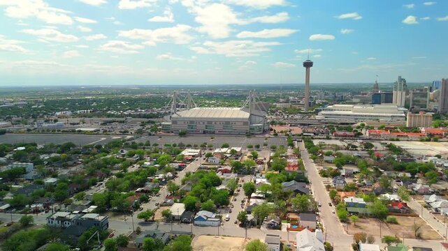 A drone pans smoothly across the downtown skyline revealing the Tower of the Americas rising above the city.