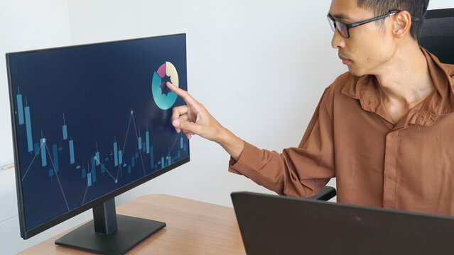 businessman working from home, using a touchscreen, plans investments, finances, returns on investment from interest rates and dividends, and analyzes business trends.