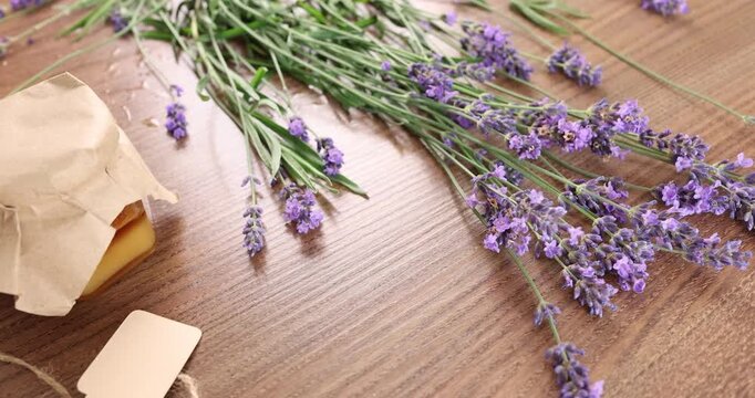 Handmade wedding favors craft ideas with lavender and sweet honey jar. Romantic rustic anniversary gift presentation layout on wooden table. Delicate marriage celebration banquet souvenirs mockup.