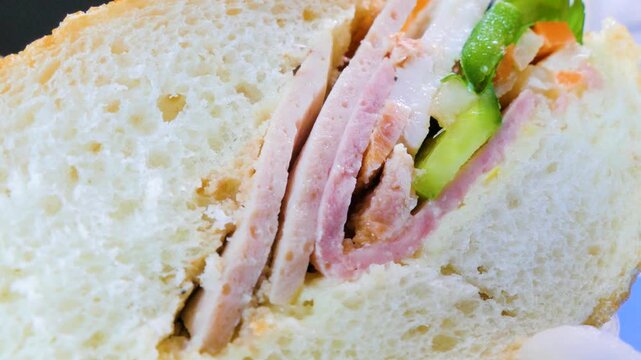 Macro cross section of fresh Vietnamese banh mi sandwich with ham
