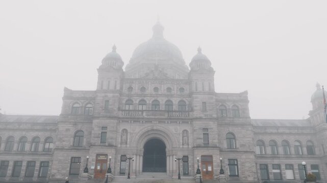Victoria, British Columbia, Canada &ndash; July 22, 2026: Person standing in front of British Columbia Parliament Buildings on a foggy morning