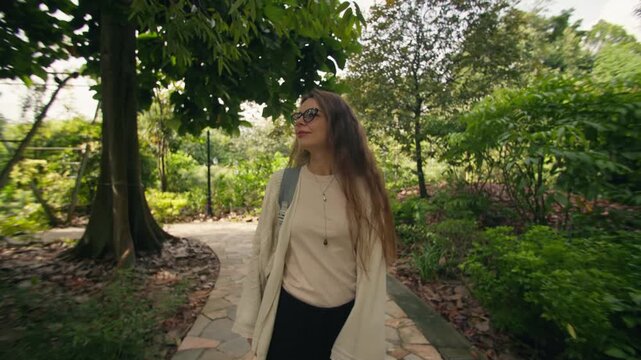 Caucasian woman exploring tropical rainforest landscapes in Singapore Botanic Gardens with exotic plants and lush greenery during travel in Asia