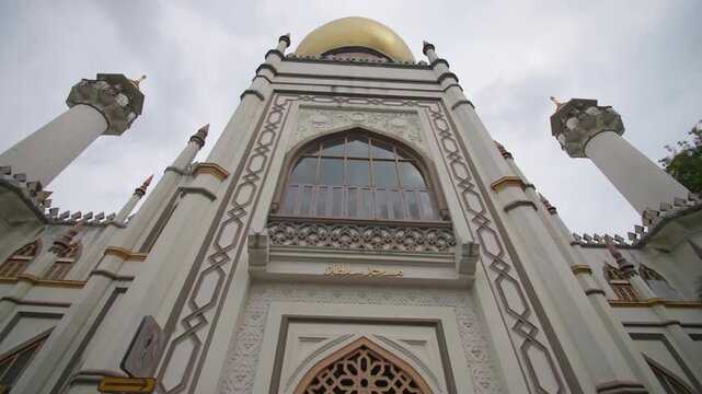Beautiful Sultan Mosque in Singapore with golden domes towering minaret and remarkable Islamic architecture creating a famous cultural destination in Asia