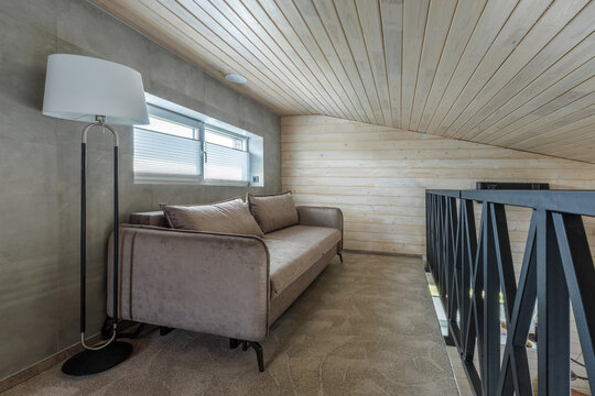 Mezzanine Floor Interior with Sofa, Floor Lamp, and Metal Railing