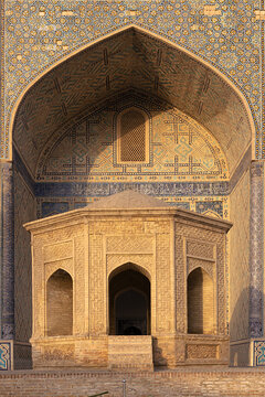 Ornate iwan portal of Kalyan Mosque in Bukhara featuring intricate tilework and brickwork pavilion. Historic Islamic architecture ideal for travel publications and cultural heritage projects.