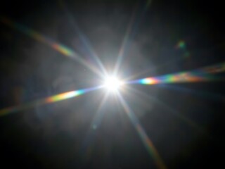 Obraz premium Bright Sunburst with Rainbow Lens Flare Across a Dark Sky.
