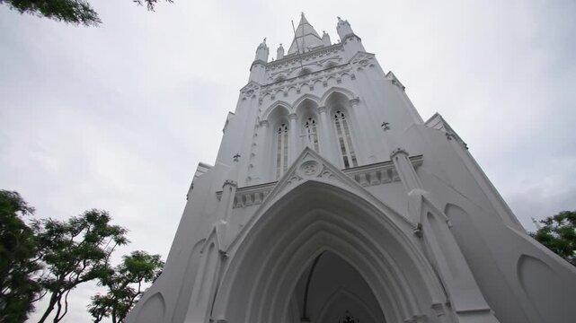 Saint Andrews Cathedral architecture in Singapore city featuring magnificent Gothic design surrounded by the downtown skyline and vibrant travel destination in Asia