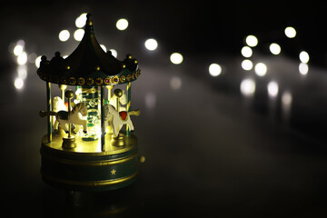 light carousel at night with horses in winter Carousel fun time Christmas night time © alexkich