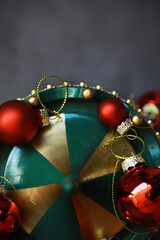Fototapeta premium Festive Christmas Wreath with Red Baubles and Gold Accents for Holiday Decor