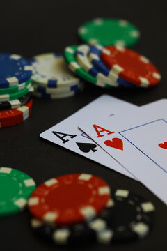 Poker Night: Close-Up of Poker Chips and Playing Cards with Aces on Green Felt Table