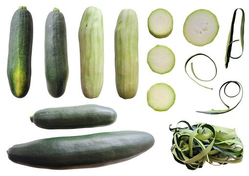 Young zucchini set, whole, peeled, sliced rounds and skin ribbons isolated on transparent background