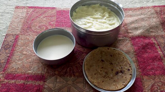 Indian home style meal with mashed potatoes milk and roti flatbread a close-up overhead view