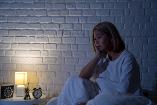 Woman is stress in bed at night.